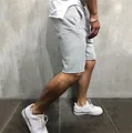 Casual men's light grey sports fitness shorts featuring a trendy raw hem and quick-dry fabric - S / Bottoms / Light Gray