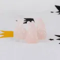 Close-up of three carved pink rose quartz rabbit figurines as cute Easter ornaments - Rose Quartz