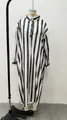 Detailed view of a long loose-fitting black and white vertical striped shirt dress. - S / Top And Bottom / Black