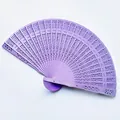 Macro view of purple hollow-carved wooden folding fan for wedding gift - 20cm / Dyed Purple