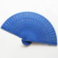 Detailed view of a vibrant blue hollow-carved wooden folding fan for wedding events - 20cm / Royal Blue