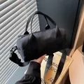 Minimalist black nylon duffle handbag for travel and fitness with adjustable strap - Black / Small