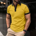 Close-up detail of a men's stylish yellow and black color-block twill cotton polo shirt. - S / Gold