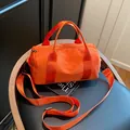 Vibrant orange cylindrical crossbody fitness bag with adjustable strap and sturdy handles. - Orange / Small