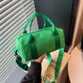 Vibrant green nylon barrel handbag with top handles and adjustable crossbody strap. - Green / Small