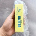 Realistic yellow salted butter squishy toy for stress relief presented in hand - Butter Stick