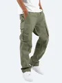 Detail view of olive green cargo pants featuring multiple utility pockets and drawstring cuffs - S / Bottoms / Green