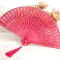 Elegant pink hollowed wooden folding fan with decorative tassel for weddings and dance - Red