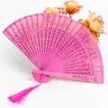 Elegant pink hollow-out carved wooden folding fan with matching tassel for wedding decor - Rose Red