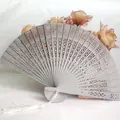 Elegant gray hollow carved wooden folding fan with white tassel for wedding gifts and dance. - Silver
