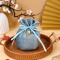 Elegant dusty blue round velvet wedding favor bag featuring a golden Double Happiness charm - With Double Happiness Pendant And Pearl / Blue