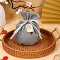 Elegant grey round velvet drawstring favor bag with silver ribbon bow and gold tag - With Double Happiness And Tag / Gray