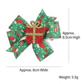 Festive Christmas hair clip featuring a green patterned bow and glittery red gift box - Christmas Gifts Model / Green