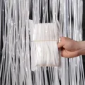 Close-up detail of 2-meter white tinsel foil fringe curtain roll for party decoration - 1x2 Meters / White