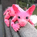 Detailed shot of a pink 3D printed articulated hairless cat figure on a stone ledge - 50cm / Season Pink