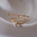 Elegante anello regolabile color oro con dolce fiocco e pietre di zircone viola brillante - Aperto Regolabile / Doppio Strato Fiocco Zirconia Viola (JZ018)