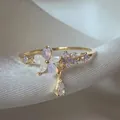 Elegante anello aperto a forma di fiore con zirconi lavanda e finitura dorata - Aperto Regolabile / Grappolo di Fiori Ciondolo Goccia (JZ027)