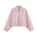 Detailed view of a retro pink short jacket with black polka dots and zipper closure - S / Tops / Pink