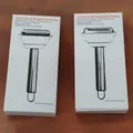 Two-pack of stainless steel 2-in-1 julienne and vegetable peelers in white retail boxes - Big Smiley Face [round Handle] Boxed