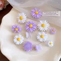 Close-up of white and purple resin daisy shoe charms on a wavy white plate - Daisy Style / Set of 12 / White-Purple
