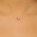 Detailed close-up of a transparent fishing line necklace with a faceted pink crystal pendant - Pink