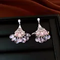 Close-up view of vintage silver needle fan earrings with shimmering pink crystals. - Fan Tassel Style (HE34448) / Pink