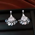 Detailed close-up of vintage fan-shaped chandelier earrings with sparkling crystals - Fan Tassel Style (HE34448) / Clear