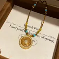 Bohemian beaded necklace with intricate gold circular pendant and turquoise accents - Gold Beaded (Ethnic Style)