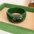 Detailed close-up of vintage green acrylic wide bangle with marbled oval gem inset - Vintage Wide Style (HB6269) / Green & Dark Green