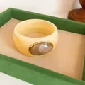 Elegant retro cream acrylic wide bangle featuring a large oval marble patterned inlay. - Vintage Wide Style (HB6269) / Beige & Light Brown