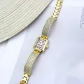 Detail view of women's gold rhinestone bracelet watch with leopard print dial - Leopard Print