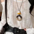 Elegant Old Money style wooden geometric necklace worn on an off-white knitted sweater - Hemp Rope Wrapped Circle Style (44#)