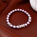 Elegante bracciale di perle viola con un ciondolo a fiocco in zircone scintillante - Viola