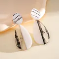 Elegant black and white marbled resin teardrop earrings with a chic minimalist design - Stud Pin Style / White