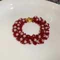Intricate detail of handmade red seed bead and white pearl bracelet with gold clasp - 77# Bracelet / Gold-Red