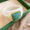 Close-up details of white acrylic bangle with square green resin stone in gold frame - Ivory Base Green Square / Ivory White-Green