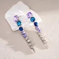 Macro view of long dangling earrings with blue and purple gradient crystals silver - Earring Post-Silver-Purple-Blue