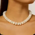 Close-up detail of white barrel beaded necklace with gold spacers for summer beach fashion - Simple Milk White Style / White