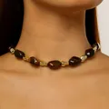 Detailed close-up showing a beaded choker necklace with brown resin and gold metallic accents - Irregular Textured / Brown