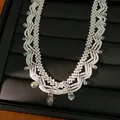 Close-up view of a white beaded lace necklace with iridescent crystal drop pendants - White (2#)