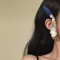 Close-up view of a New Chinese style floral tassel hair clip worn by a female model. - Water Drop Tassel (HH9952) / Single Piece / Silver Blue