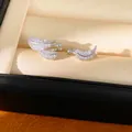 Macro view of silver-toned leaf ear cuffs encrusted with sparkling clear zircons - Feather/Leaf Style / Pair Pack / Silver