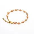 Bracelet en acier inoxydable doré avec des breloques œil turc rose poudré. - Œil Rose