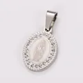 Detailed view of a vintage oval stainless steel religious pendant with rhinestone border - Round Virgin Mary / Steel