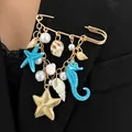 Detail of ocean theme brooch with starfish, seahorse, and shell charms on black blazer. - Starfish Seahorse Tassel Style (11864) / Blue