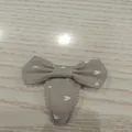 Taupe fabric children's bow hair clip with white heart pattern and wavy edge. - Khaki With Heart