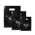 Set of black plastic shopping bags with silver thank you print and die-cut handles. - 35*45cm / Black Star with Gold Text