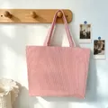 Large red and white striped tote bag hanging on a wooden hook in a bright lifestyle setting - Deep Pink