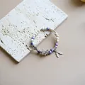 Jingdezhen ceramic beaded bracelet featuring purple beads and a silver butterfly charm - Shunanci (1002-02) / Purple