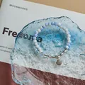 Blue and white gradient ceramic bead bracelet with a vintage silver shell charm - Shell (1006-09) / Blue
